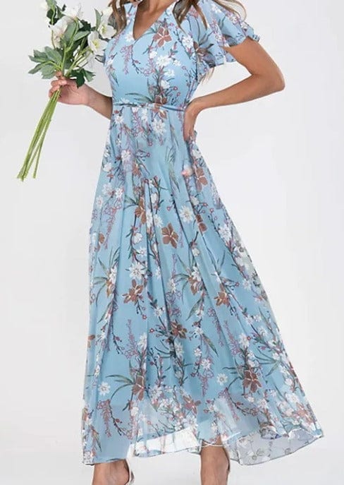 Light blue floral maxi summer dress held with a bouquet of white flowers