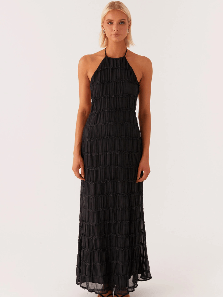 Front view of a model in a black Timeless Evening Dress with a halter neckline and horizontal ruched details
