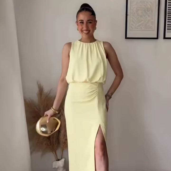 Elegant midi dress worn by model, front view, holding a gold clutch and smiling