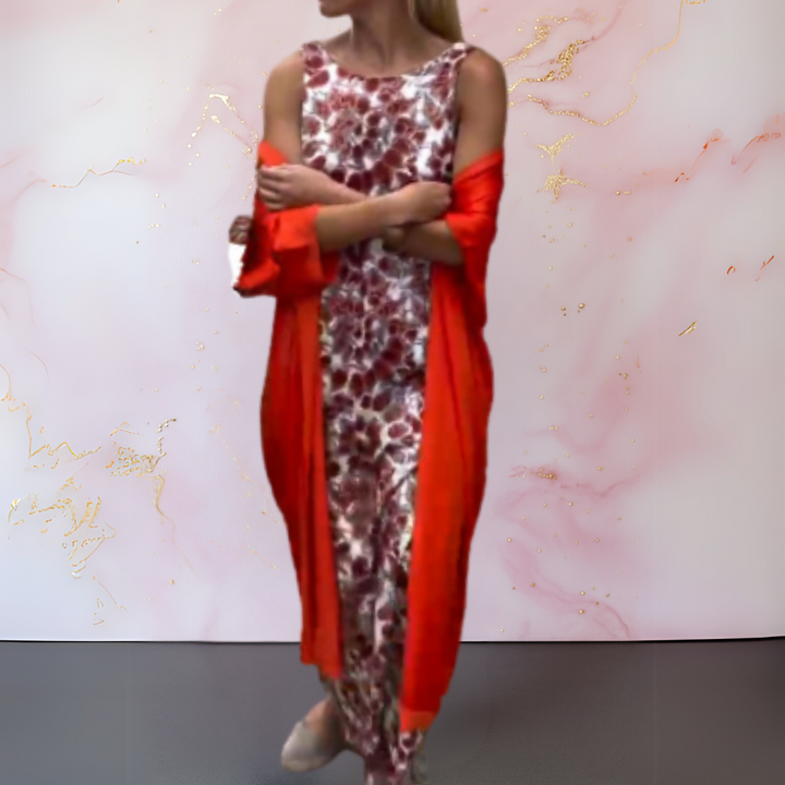 Three quarter view of a model in a floral print boho maxi dress with a long red cardigan