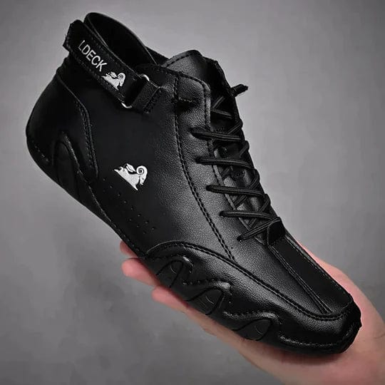 Three quarter view of a black Orthopedic Comfort Boot with anti-slip sole and laces, held in a hand