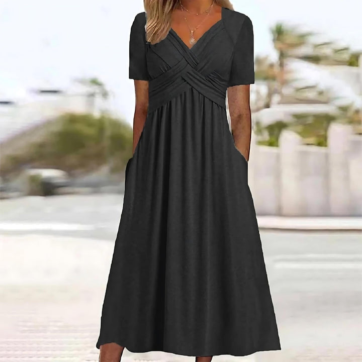 Front view of the black Evelyn midi dress worn by a model, showcasing the flattering ruched bodice