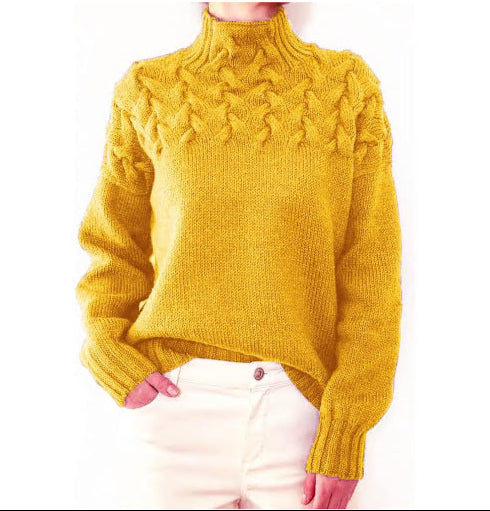 Front view of a model wearing a yellow cable knit mock neck sweater with cream trousers, hand in pocket