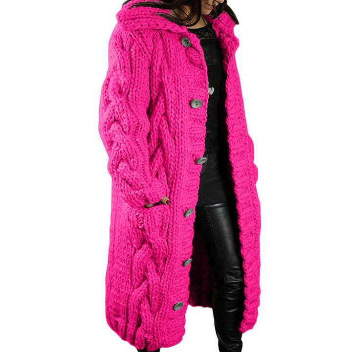 Side view, model wearing a long hot pink oversized wool blend cardigan with chunky cable knit, hood and buttons
