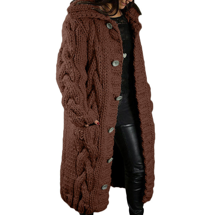 Three quarter view, model wearing a long brown oversized wool blend cardigan with chunky cable knit, hood and buttons