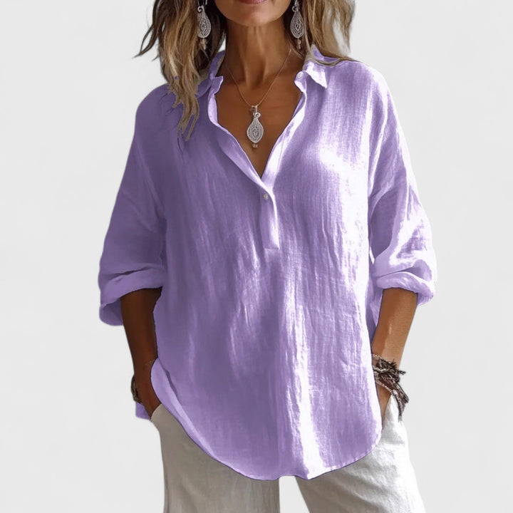 Front view, worn by model, of a lavender cotton-blend oversized blouse with rolled-up sleeves and a v-neck collar