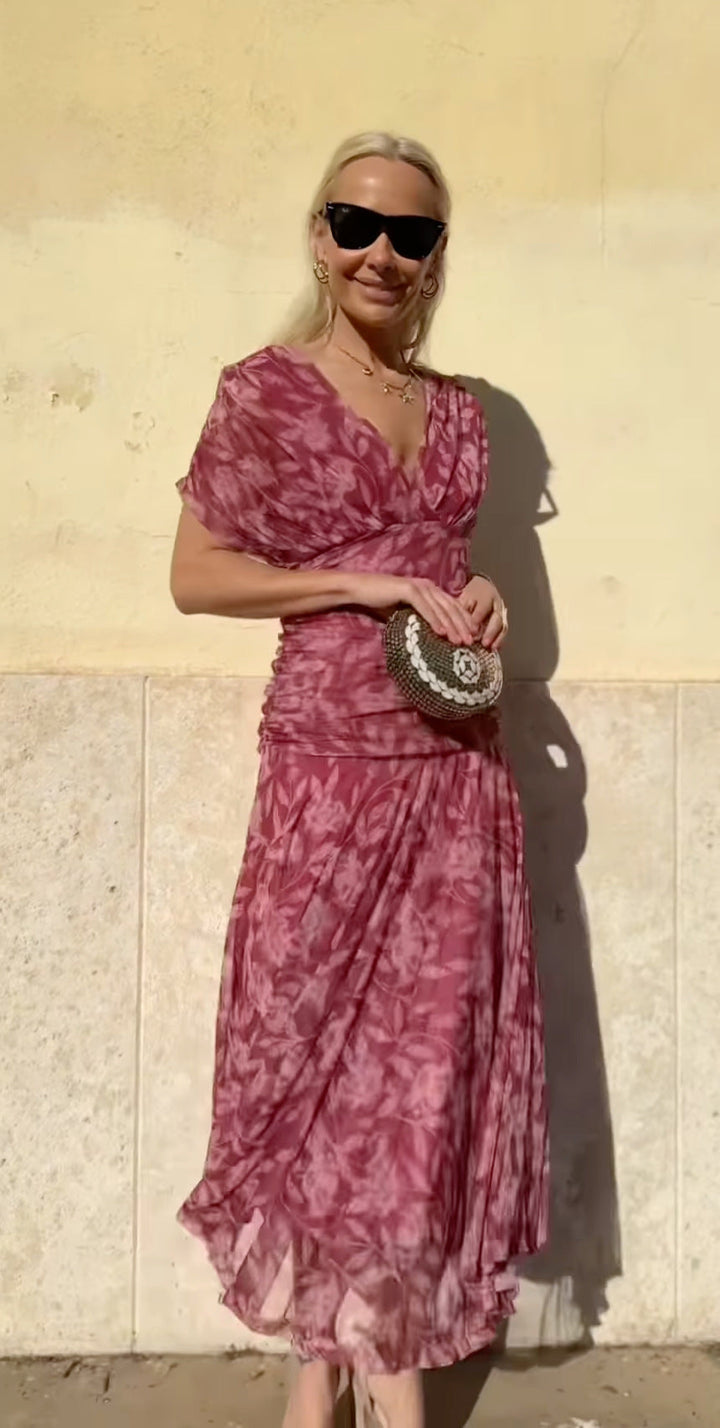 Front view, worn by model, of the Christi Off-Shoulder V-Neck Printed Dress with a gold necklace and sunglasses