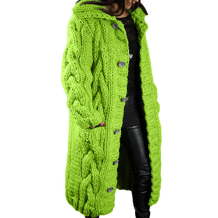 Three quarter view, model wearing a long lime green oversized wool blend cardigan with chunky cable knit, hood and buttons