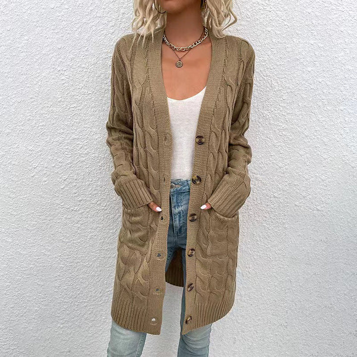 Front view of a model in a long camel cable knit cardigan with large buttons and pockets