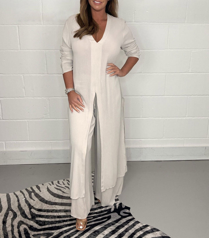 Front view of a model in a jade two-piece wide leg jumpsuit set with a long tunic top and v-neck, hand on, alternate angle