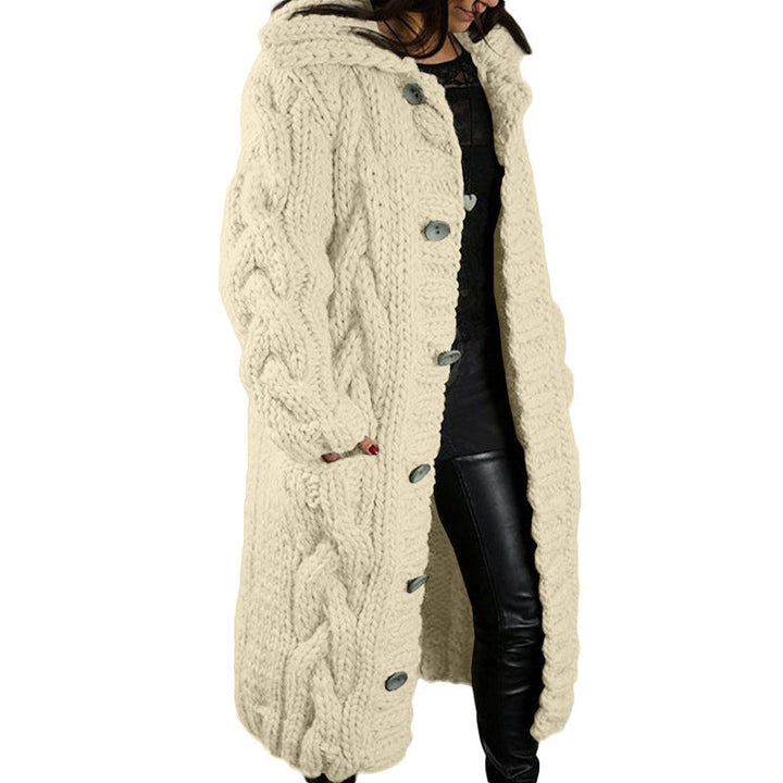 Three quarter view, model wearing a long cream oversized wool blend cardigan with chunky cable knit and buttons