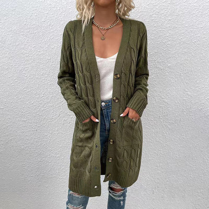 Front view of a model in a long olive green cable knit cardigan with large buttons, pockets, and ribbed cuffs