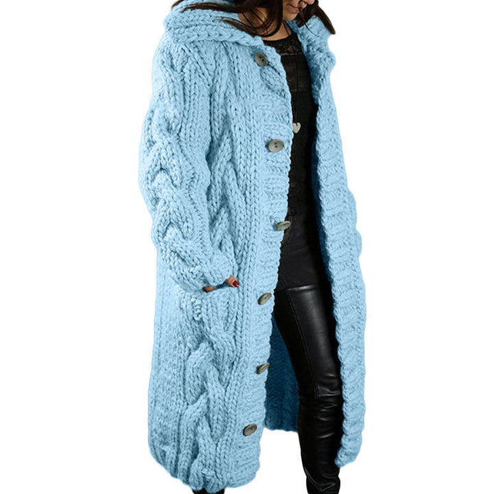 Front view, model wearing a long light blue oversized wool blend cardigan with chunky cable knit, hood and buttons