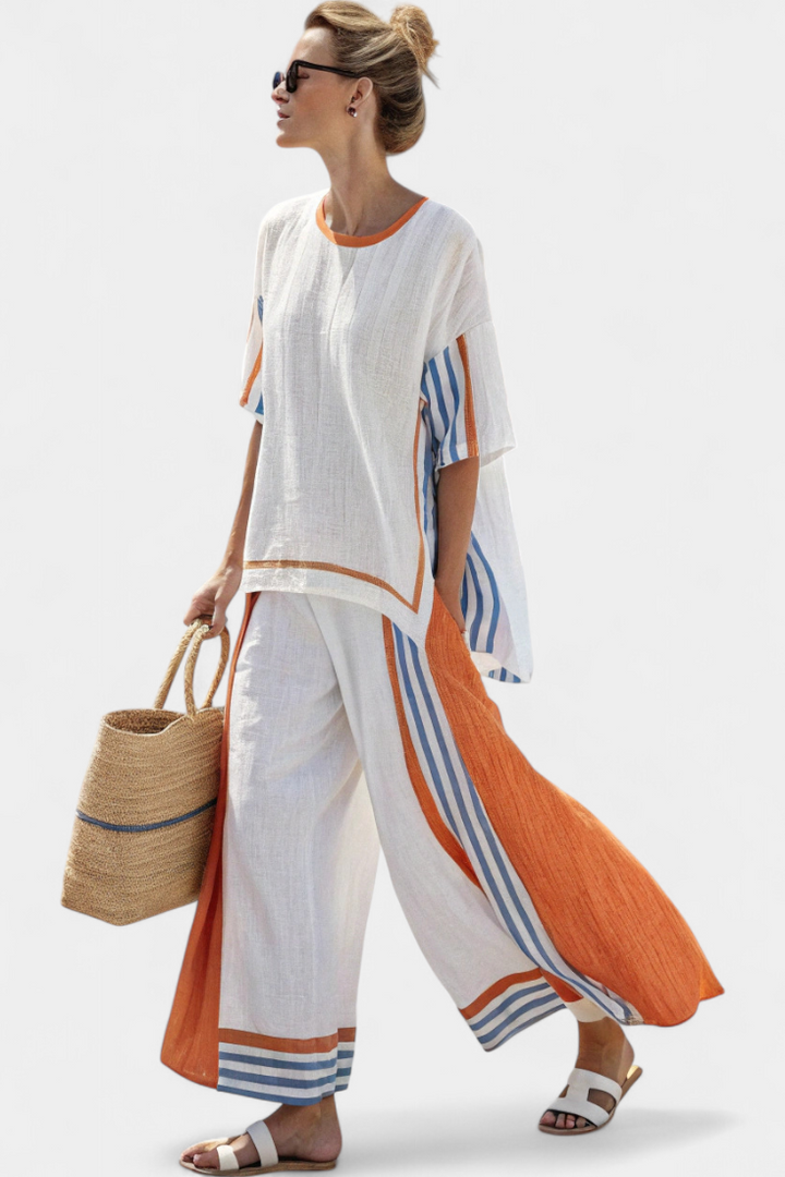 White two piece linen suit with orange and blue striped trim, side view