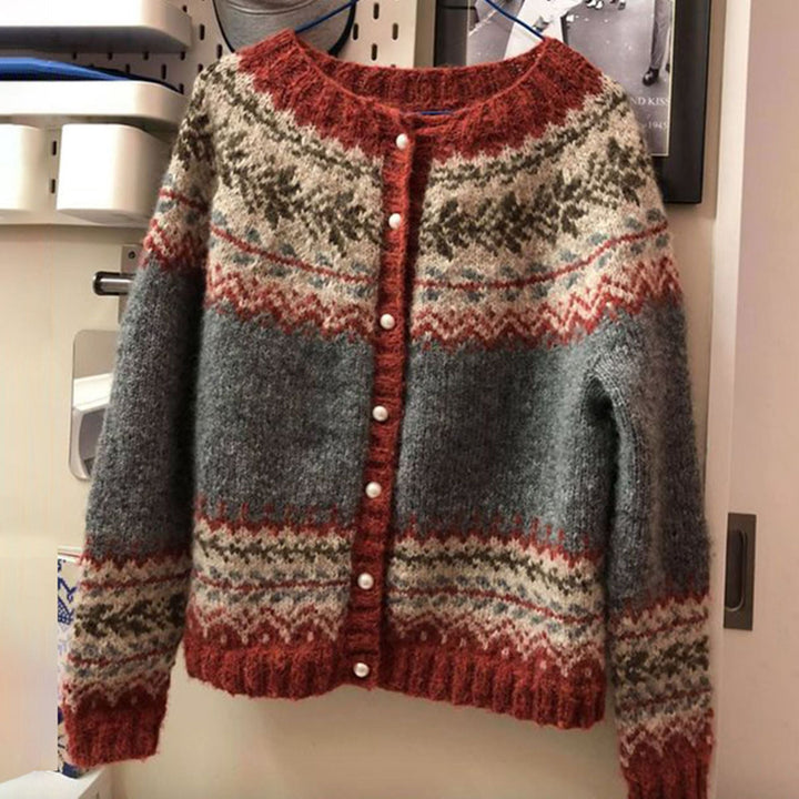 Front view of a Freya Cozy Sweater in grey, cream, and burnt orange, with pearl buttons and a patterned yoke