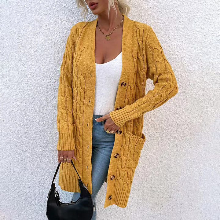 Front view of a model in a long mustard yellow cable knit cardigan with large buttons and pockets
