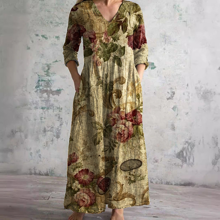 Front view of a model wearing a lightweight boho floral V-neck summer dress, bare feet visible