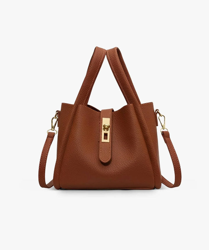 Front view of the Valeria vegan leather handbag in tan with a gold turn-lock clasp and shoulder strap