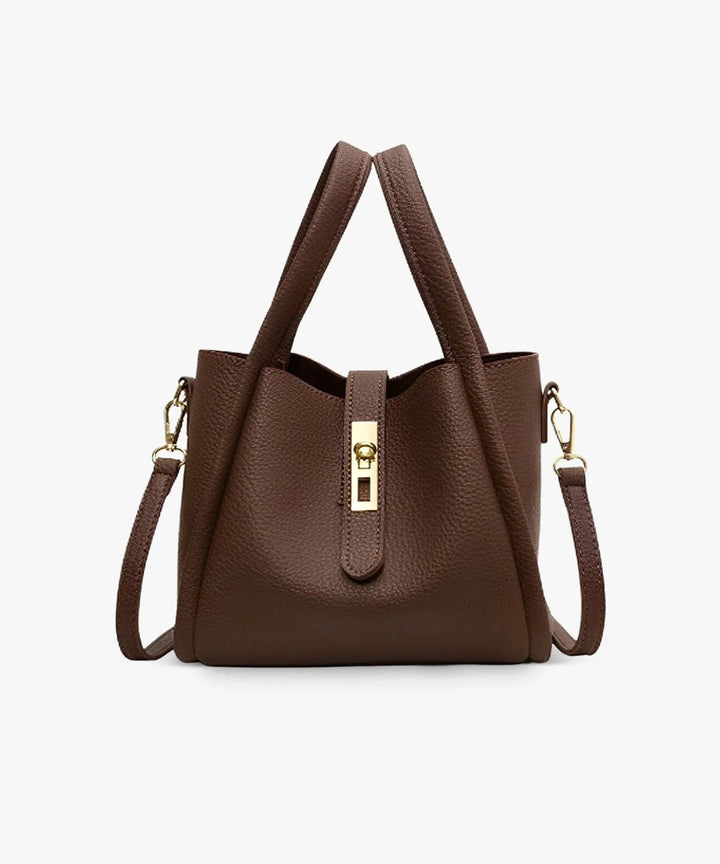 Front view of the Valeria vegan leather handbag in dark brown with a gold turn-lock clasp and shoulder strap