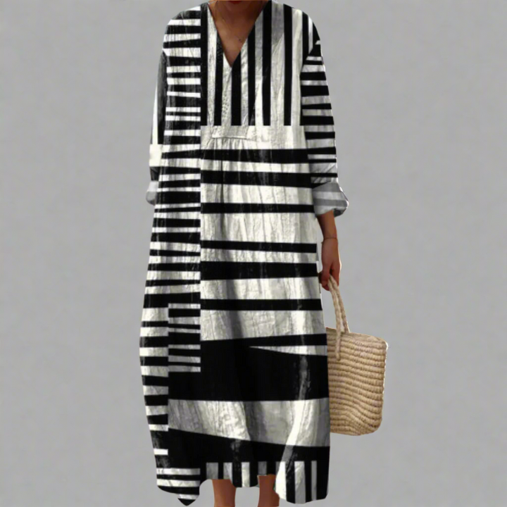 Front view of the Doris Geometry Dress, a black and white striped cotton midi dress worn by model
