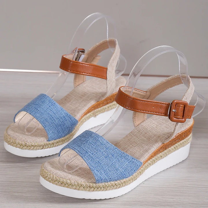 Side view of Vera Retro Wedge Sandals on clear stands, showing brown ankle straps and blue denim toe straps