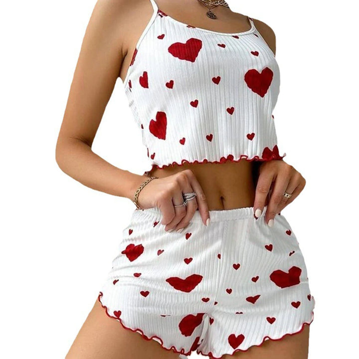 Close up of a model wearing a white pyjama set with red hearts, showing the soft sleepwear fabric