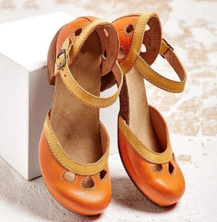 Back view of orange retro colour-block sandals with yellow buckle straps and a brown mid-heel