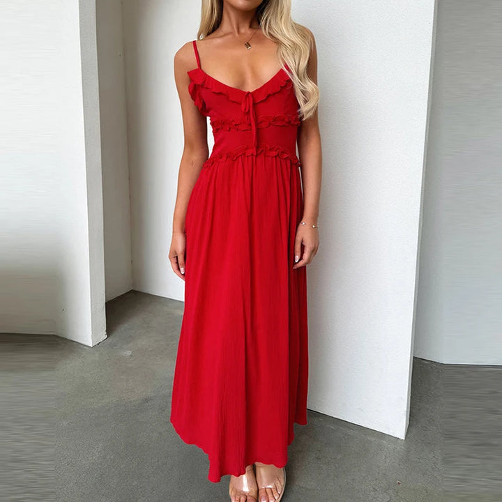 Front view, model wearing a red pleated V-neck beach dress with ruffled trim, smocked bodice, and ankle length A-line skirt