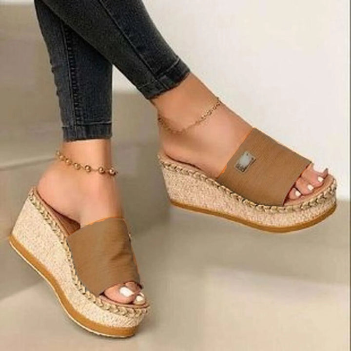 Worn by model, Kaya Summer Platform Sandals with tan straps and woven wedge heels, paired with dark jeans