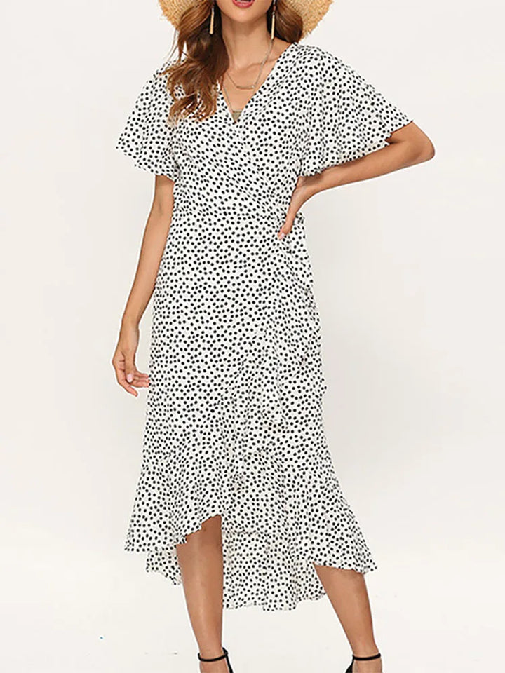 Front view of model in an elegant boho floral chiffon maxi dress with a ruffled high low hem and side split, alternate angle