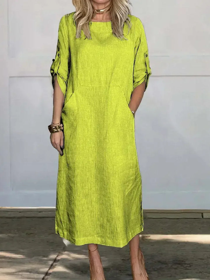 Front view of the Emma Linen Midi Dress in lime green with rolled short sleeves and a model&