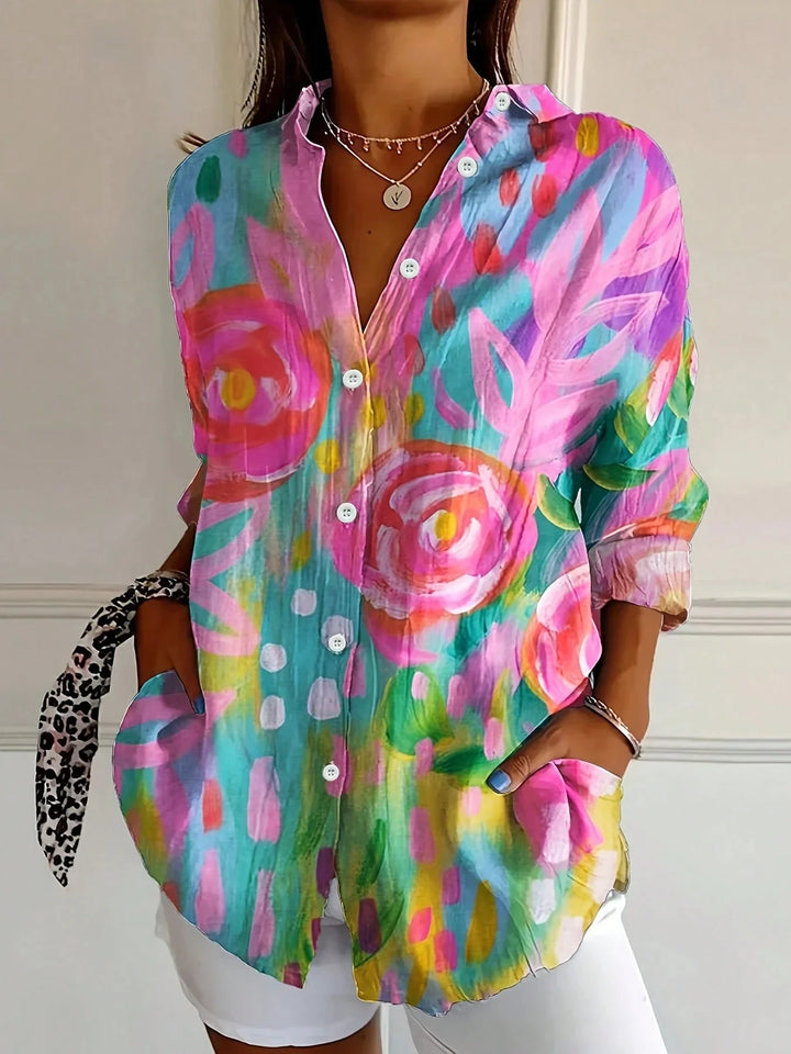 Multicoloured abstract floral print blouse worn with white shorts, front view