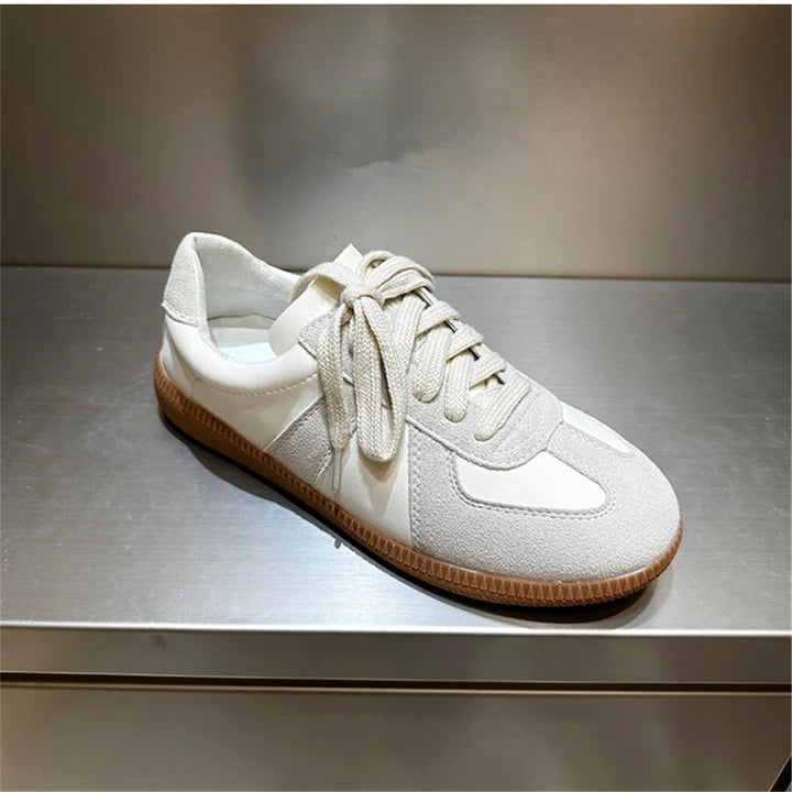Three quarter view of a light beige Nova genuine leather sneaker with suede toe and tan laces