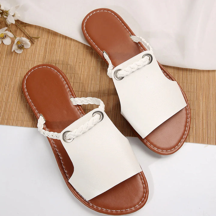 Top view of a pair of white Maya Square-Toe Flat Sandals with braided back straps and silver eyelets