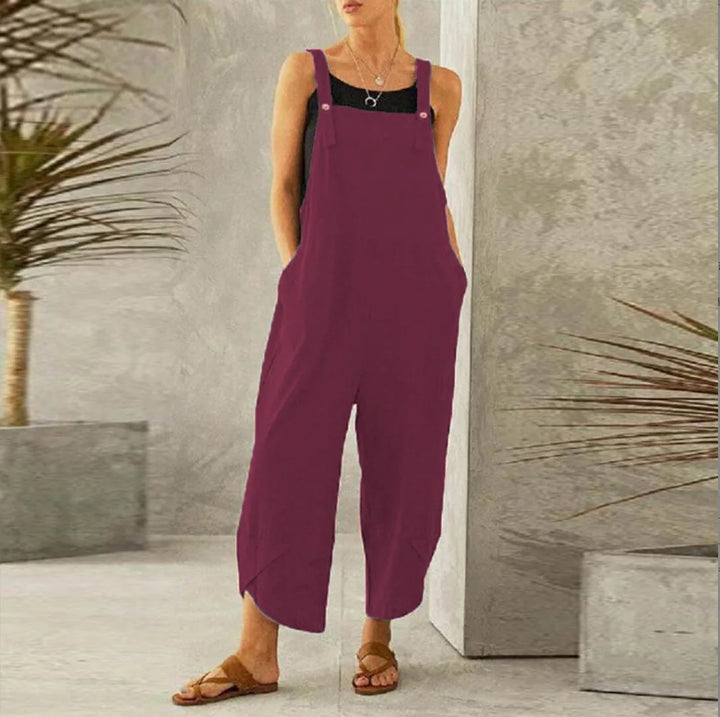 Burgundy oversized cotton linen dungarees worn with tan sandals, front view