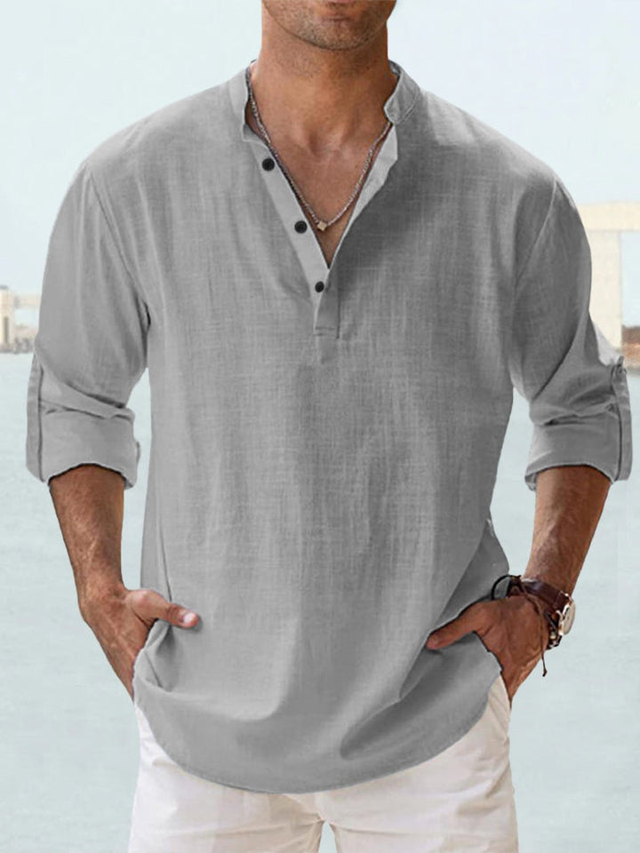 Front view of a man wearing a grey breathable cotton shirt with a Henley collar and rolled up sleeves