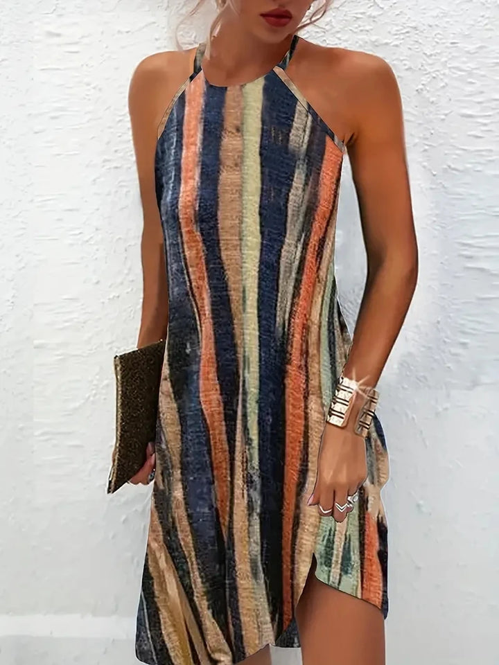 Front view of the Luna Relaxed Beach Dress worn by model, featuring colourful vertical stripes and a side split