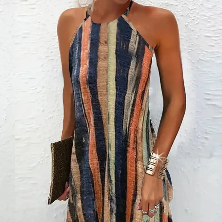 Front view of the Luna Relaxed Beach Dress worn by model with a clutch and cuff bracelet