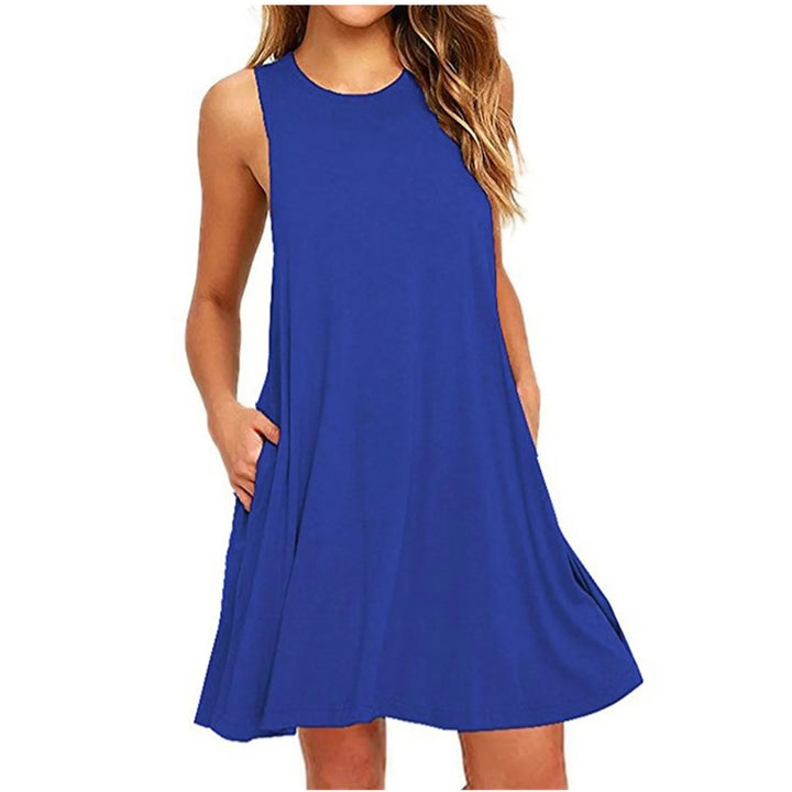 Front view worn by model of a blue casual summer beach dress with hands in pockets showing pleats