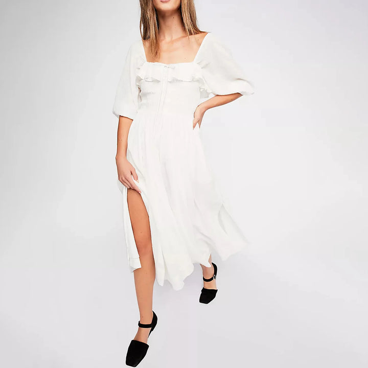 Fairycore square neckline mid-calf dress, worn by model in a white dress with a leg slit and black shoes