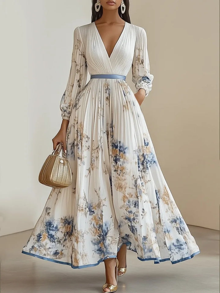 White and blue floral patchwork maxi dress with a gold clutch
