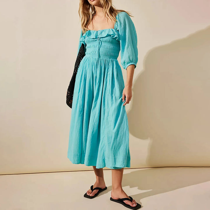 Fairycore square neckline mid-calf dress, worn by model, a woman in a blue dress with a black bag and sandals