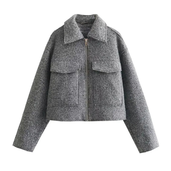 Close up of the grey cropped tweed zip jacket showing the texture and front pockets