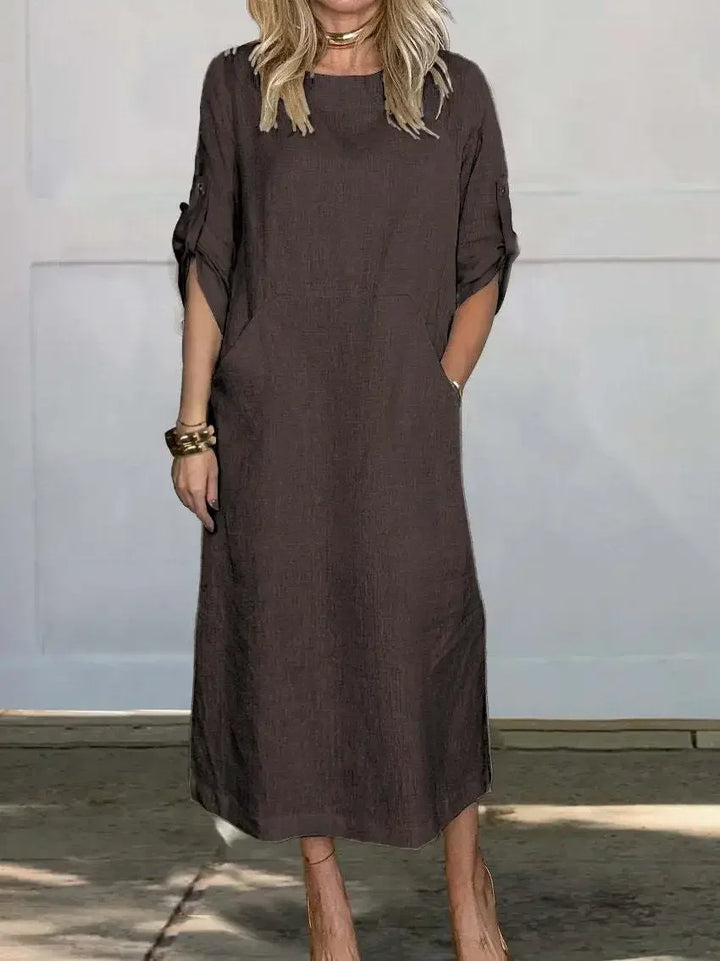 Front view of the Emma Linen Midi Dress in dark brown with rolled short sleeves and a model&
