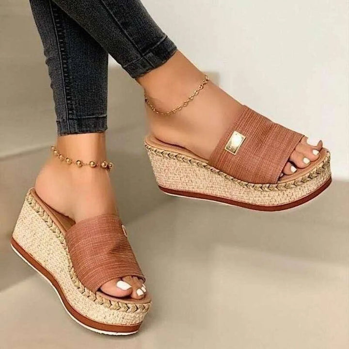 Side view, Kaya Summer Platform Sandals with brown straps and woven wedge heels, worn with dark jeans