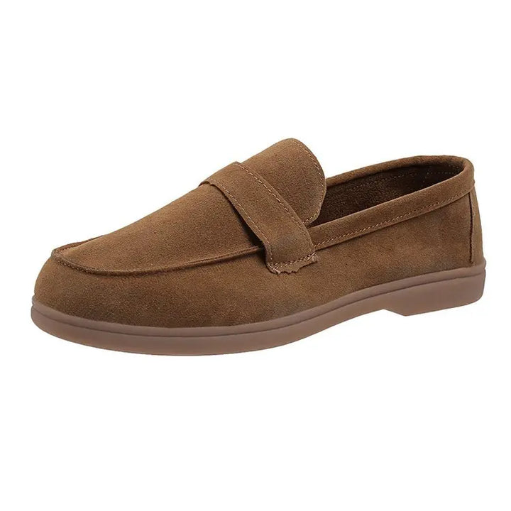 Side view of a single brown suede loafer with a brown sole on a white background