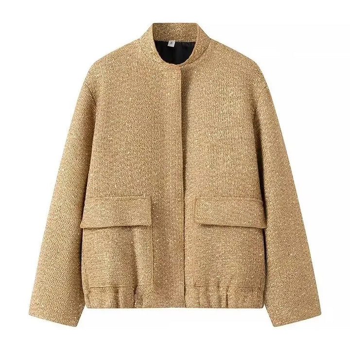 Flat lay of a shiny gold sequin short jacket with a high collar and two front pockets