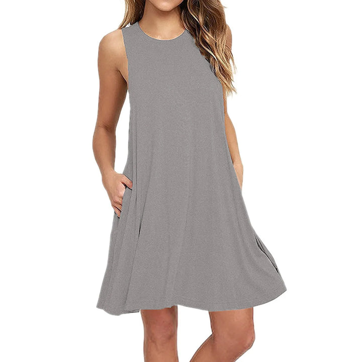 Front view worn by model of a grey casual summer beach dress with hands in pockets