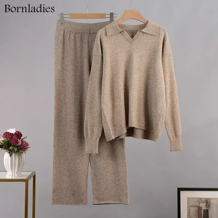 Flat lay of a brown cozy knitted two-piece set, featuring a polo neck sweater and wide-leg pants on hangers
