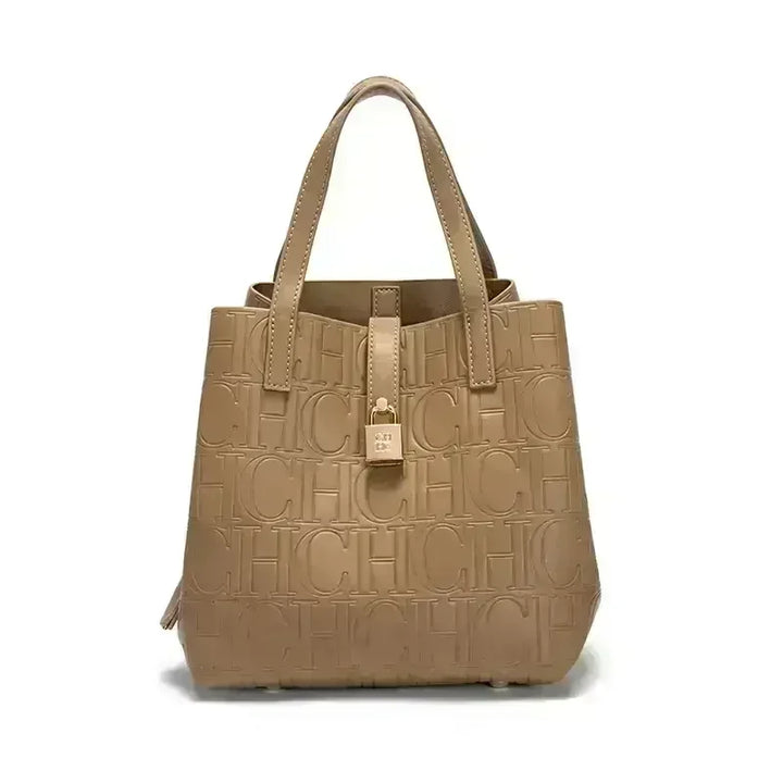 Front view of a beige Kara Classic Large Bucket Handbag with embossed &